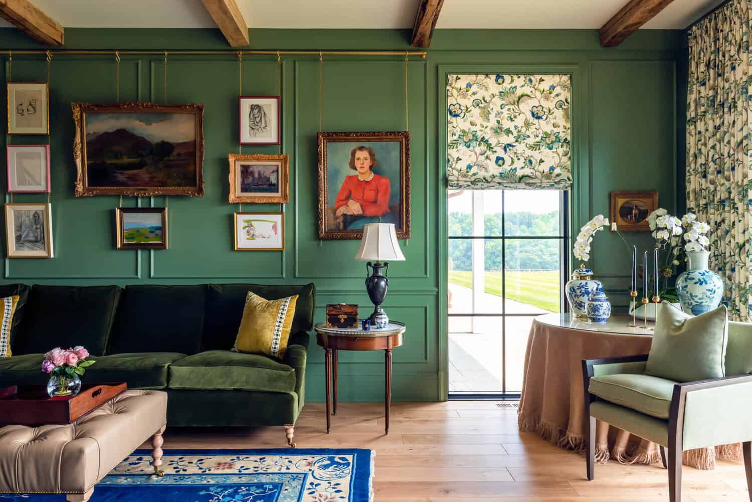 Green sitting room with gallery wall and floral roman shade