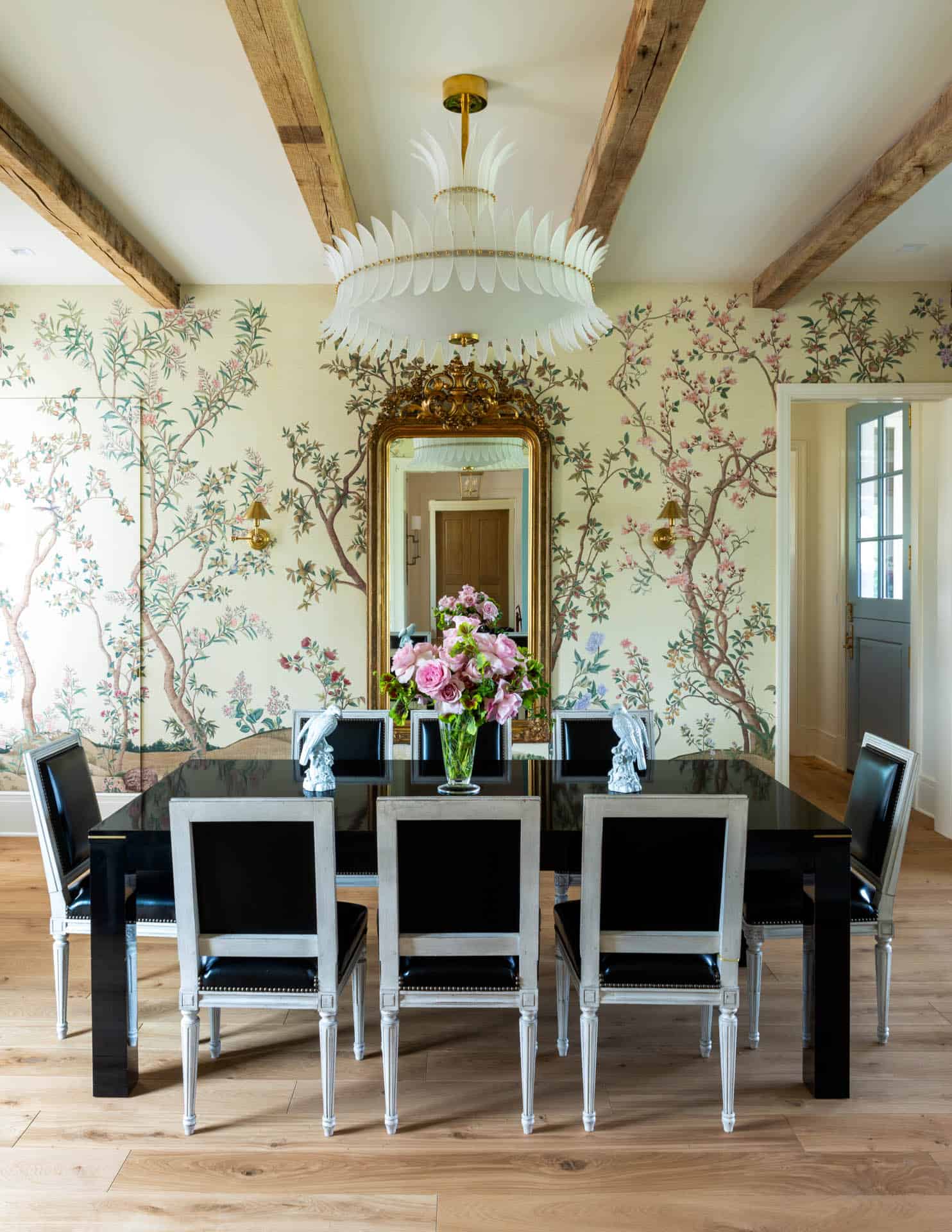 Dining room with gilt mirror and feather chandelier