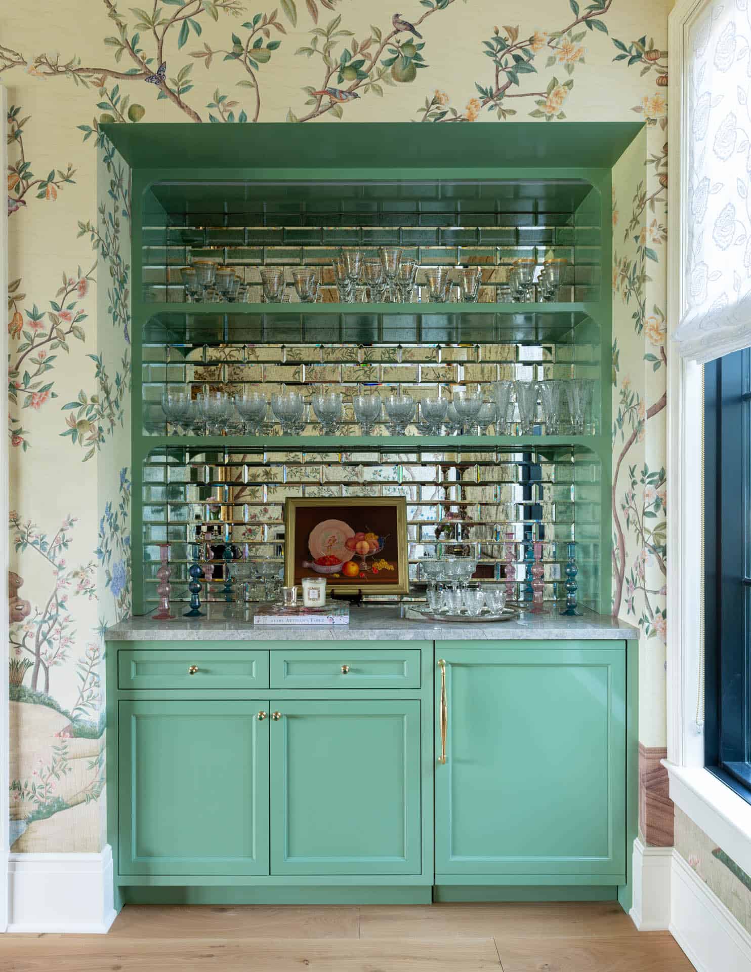 Green built-in bar with antique mirrored glass shelving