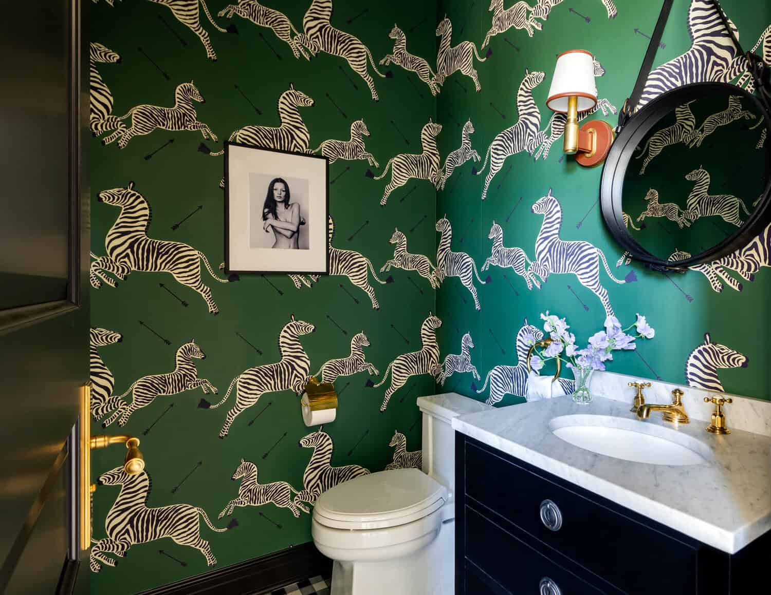 Powder room with green zebra print wallpaper and gold fixtures