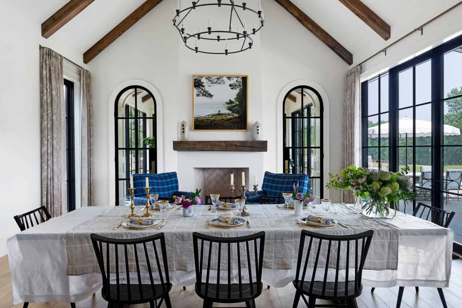 Vaulted dining room with wood beams and arched glass doors