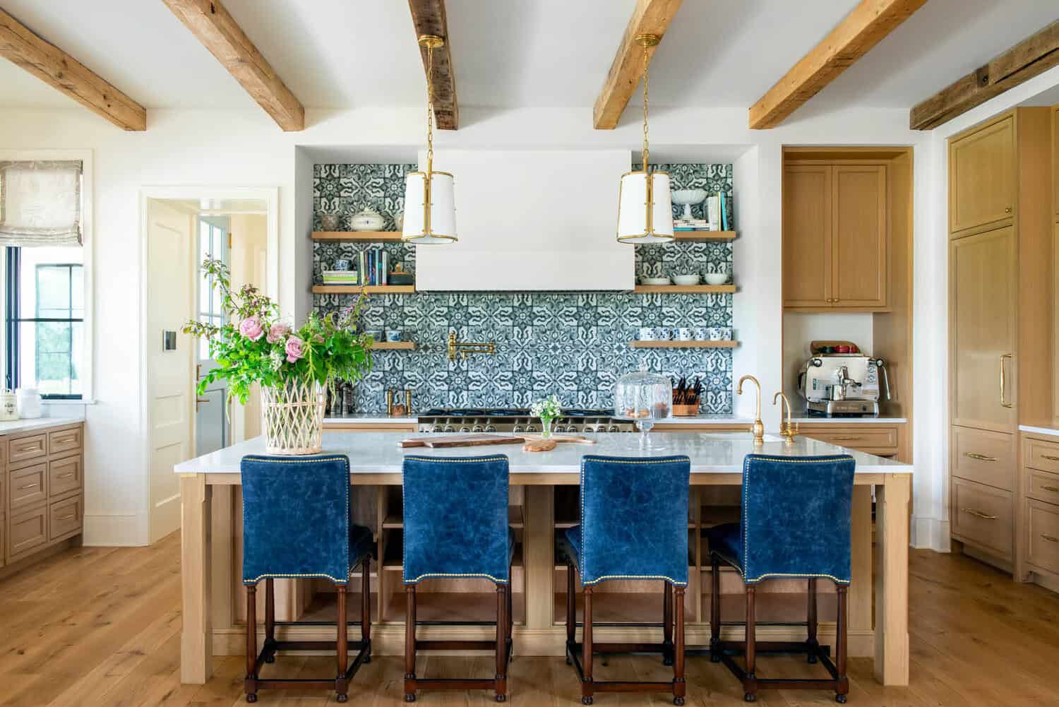 Kitchen island with blue leather stools and patterned tile backsplash