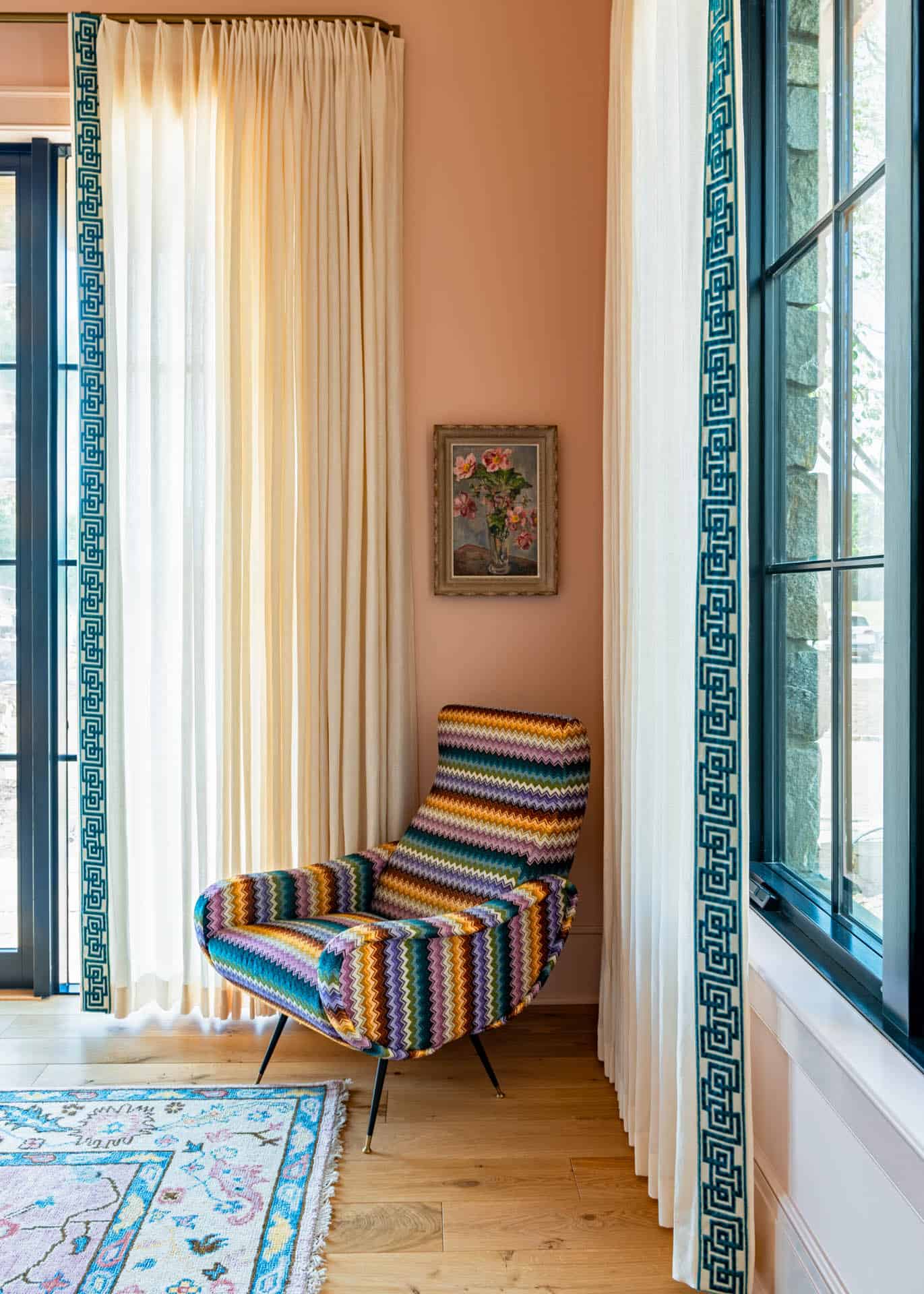 Reading nook with chevron chair and coral accent wall