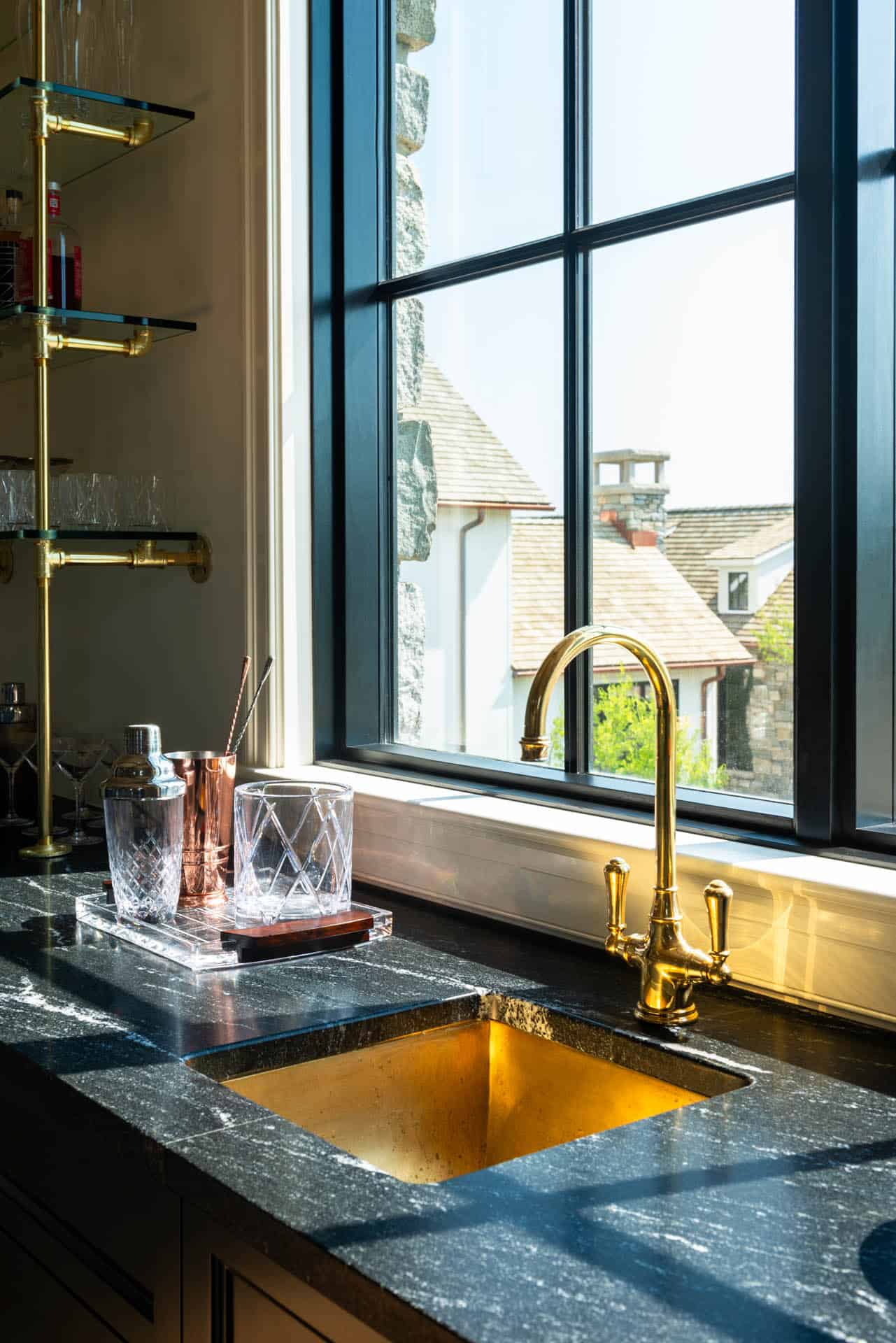 Bar counter detail with brass fixtures and gold sink