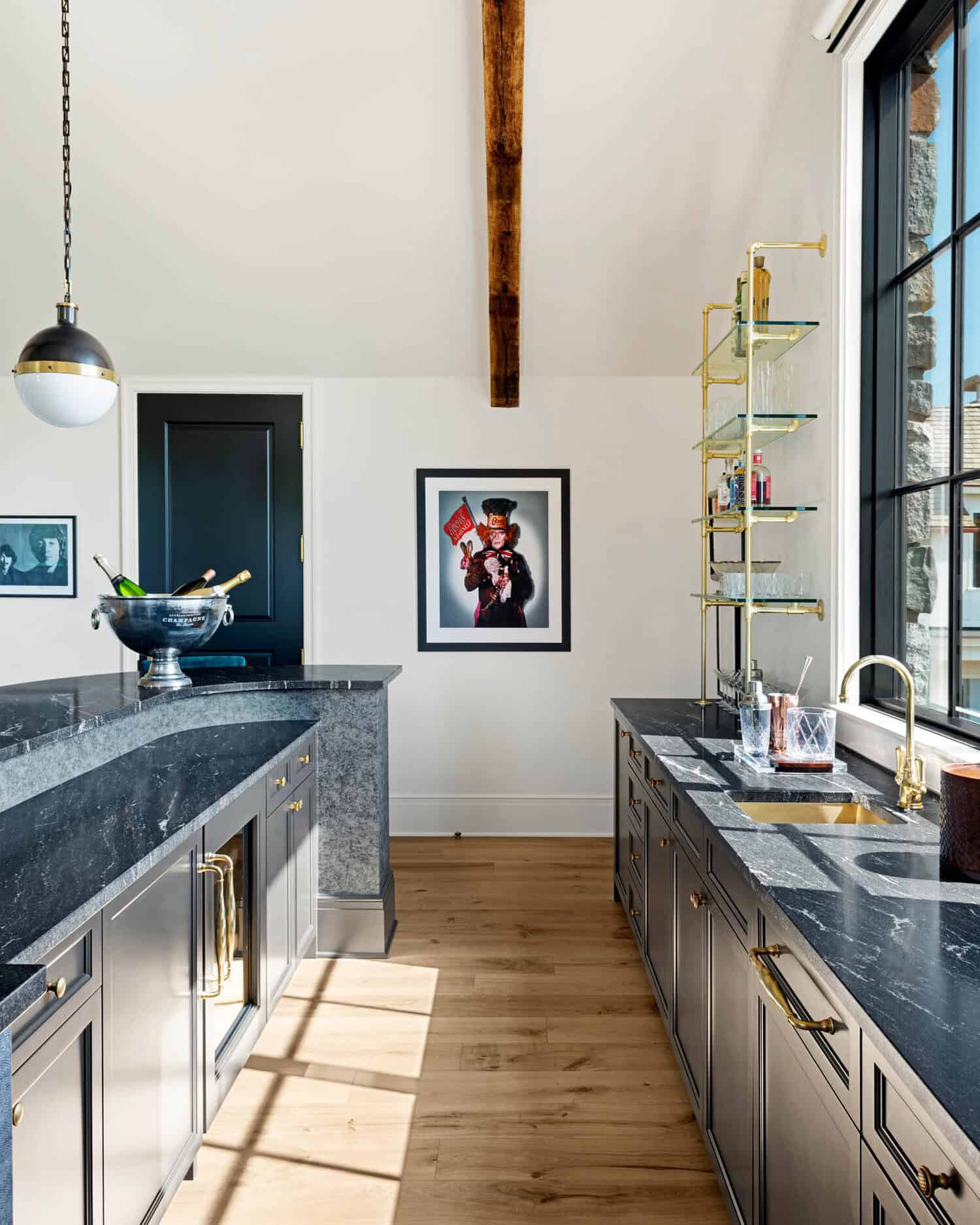 Butler's pantry with marble counters and glass shelving