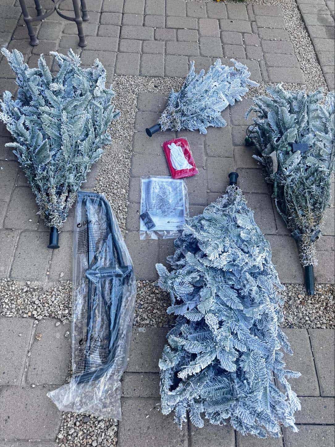 Green King of Christmas storage bag open with flocked artificial tree branches inside
