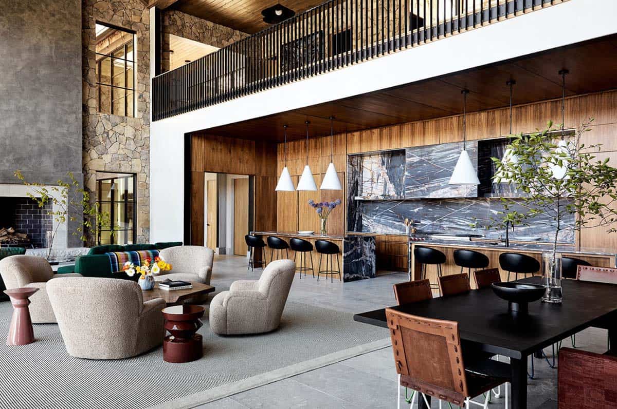 Double-height great room with wood ceiling and stone fireplace wall