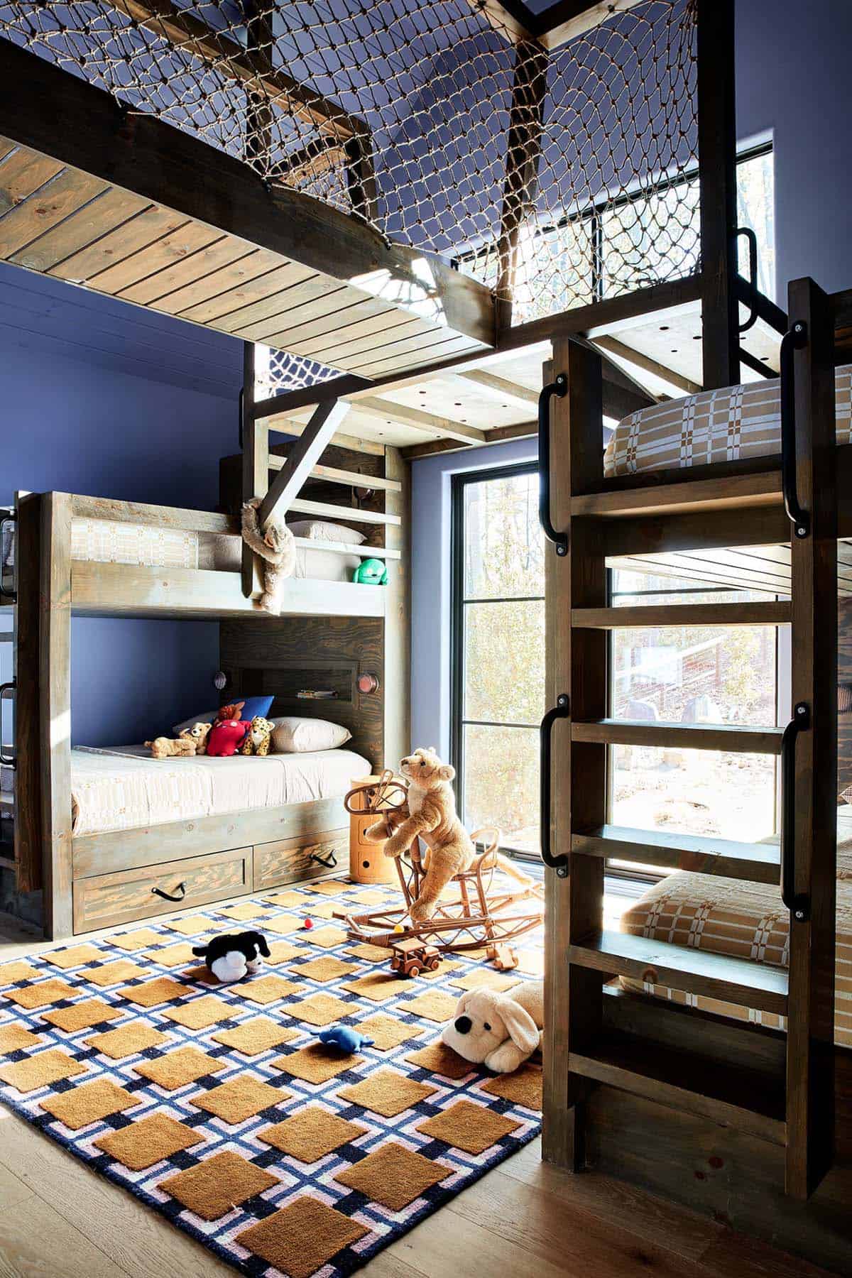 Bunk room with rope netting loft and plaid upholstered beds