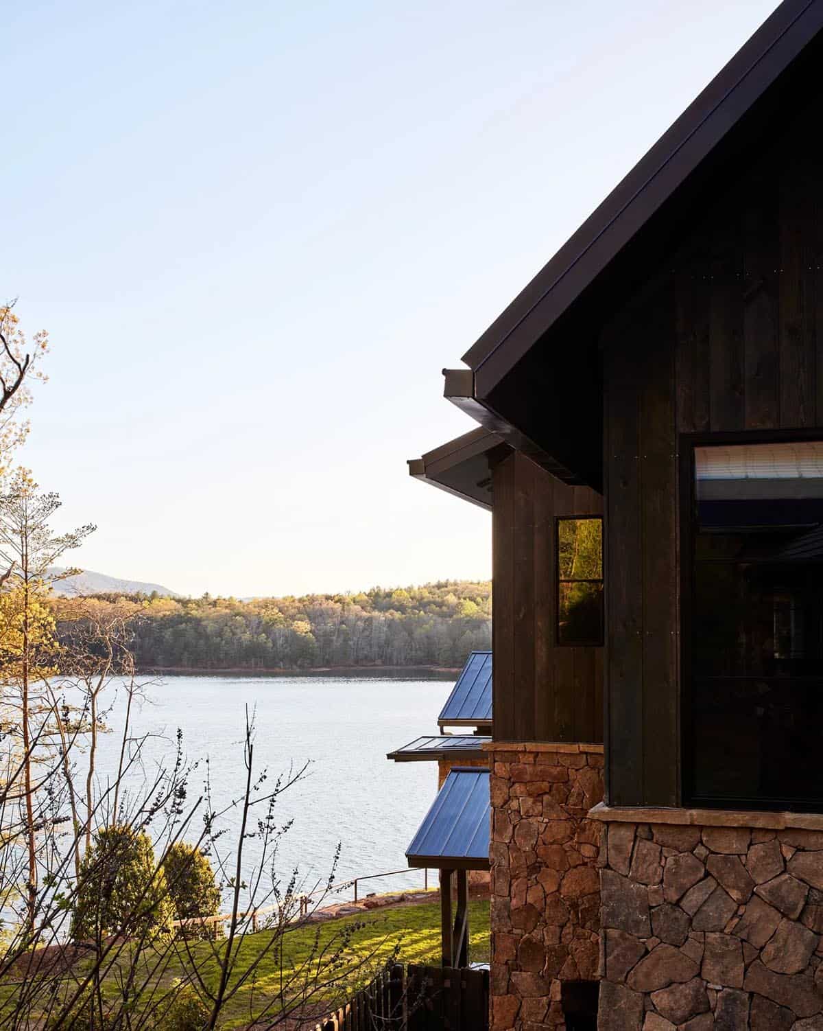 Stone and dark wood exterior detail with lake and mountain backdrop