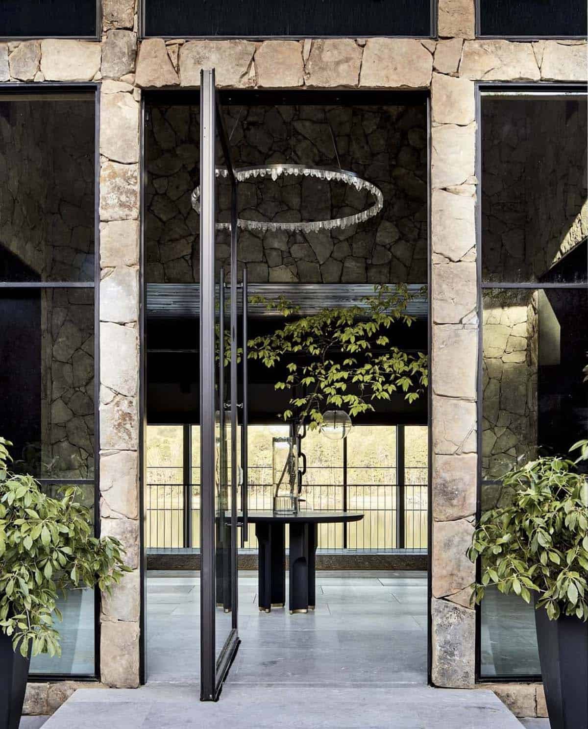 Front entry doorway with circular crystal chandelier and stone surround