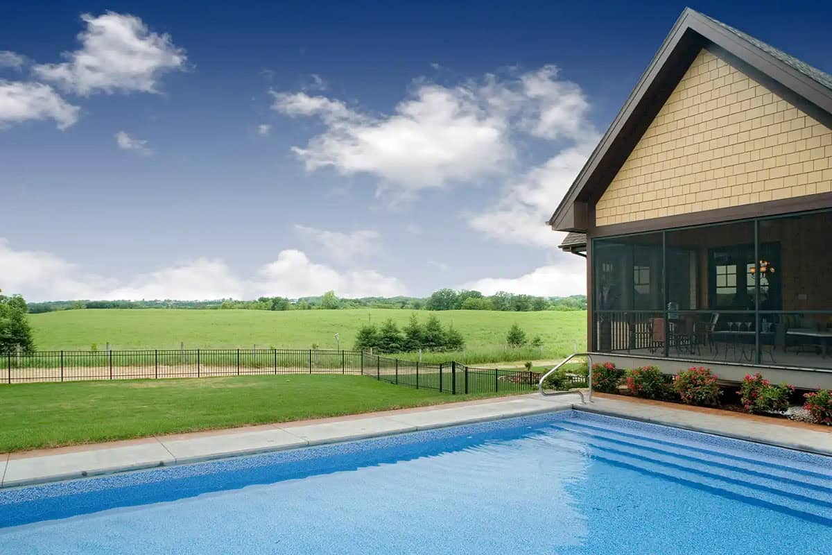Swimming pool with screened porch and open farmland view