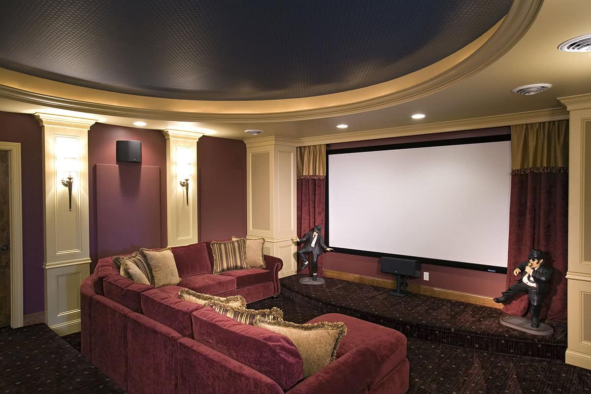 Home theater with red sectional sofa and curved projection screen