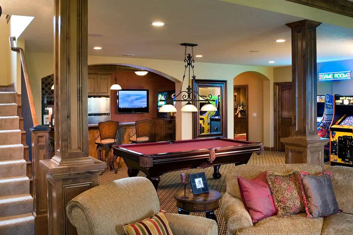 Basement game room with pool table and wet bar seating