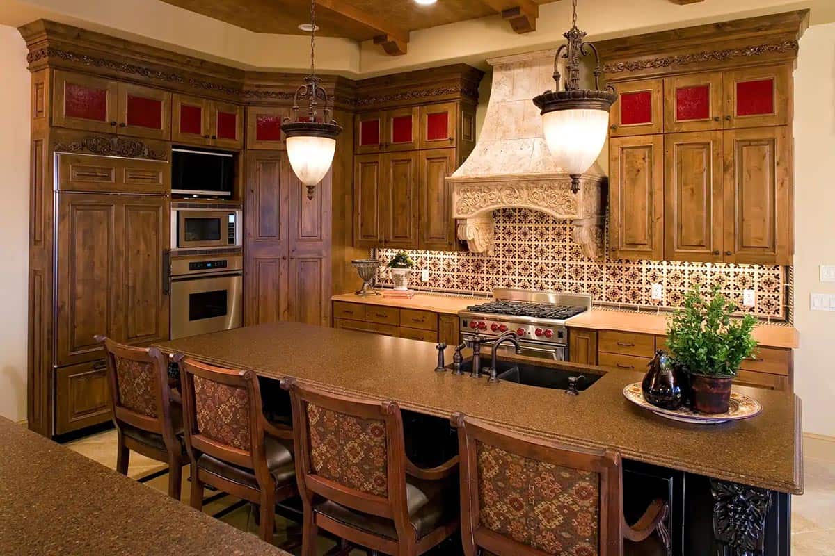 Kitchen with carved stone hood and patterned tile backsplash