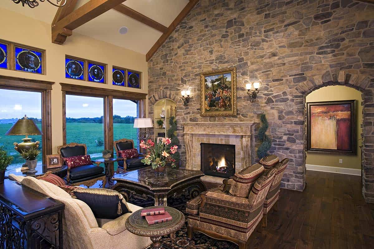 Living room with stone fireplace and floral upholstered armchairs