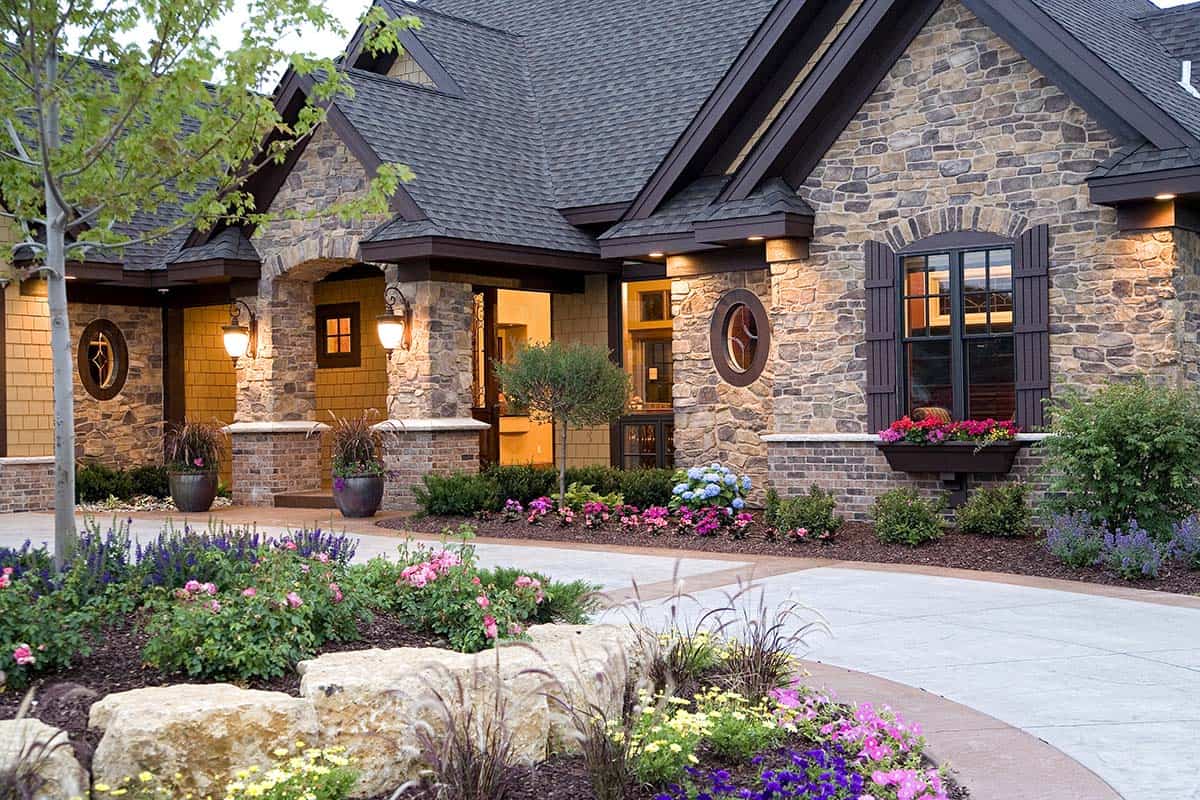 Stone exterior with arched porch and covered entryway