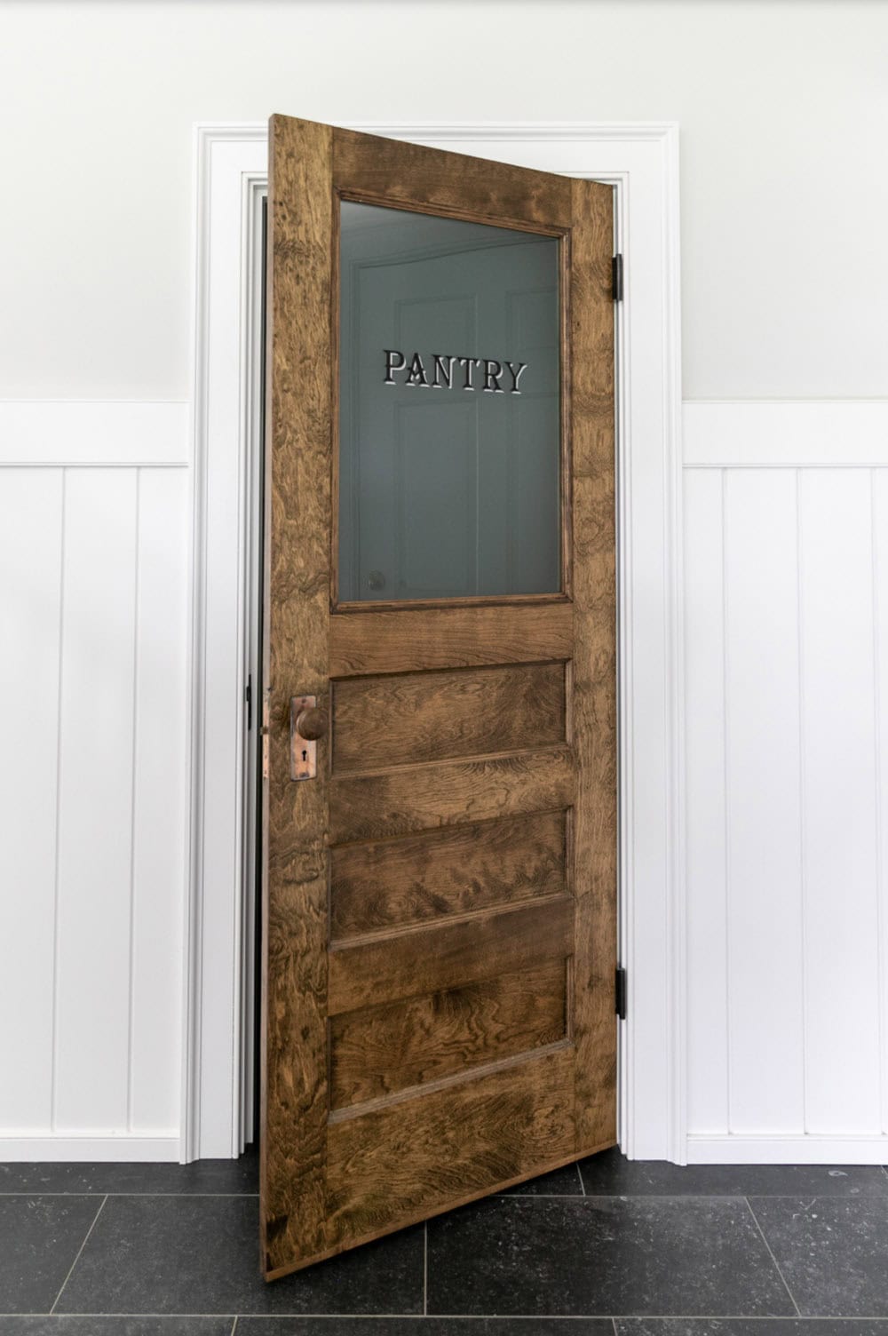 Reclaimed wood pantry door with etched glass panel reading "Pantry"