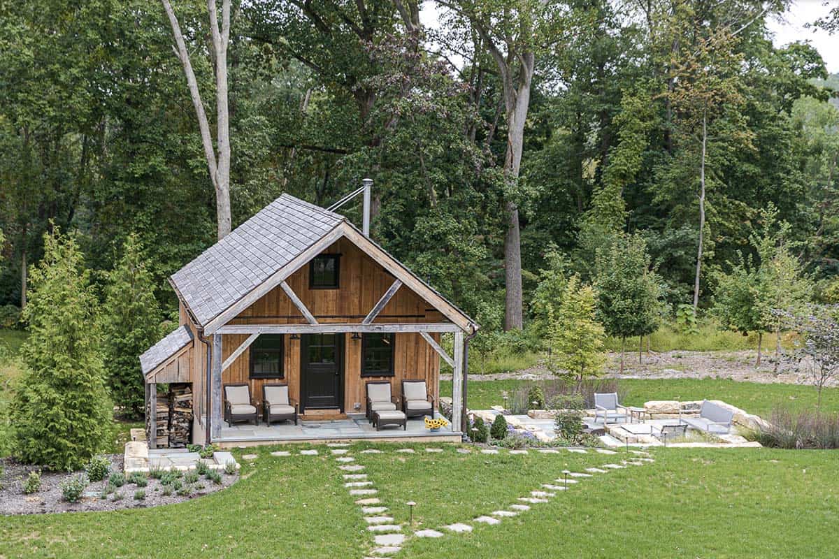 Aerial view of the timber-frame guest cabin with covered porch and stone garden path