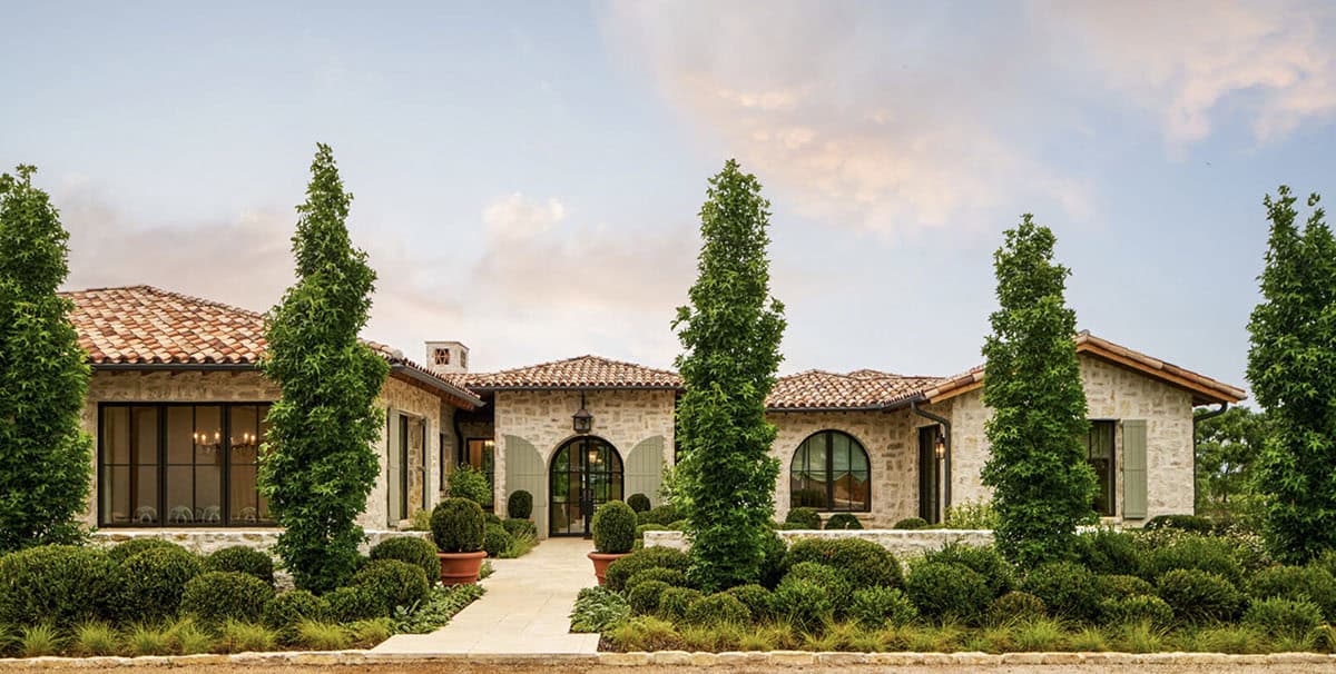 mediterranean inspired home front exterior with landscaping