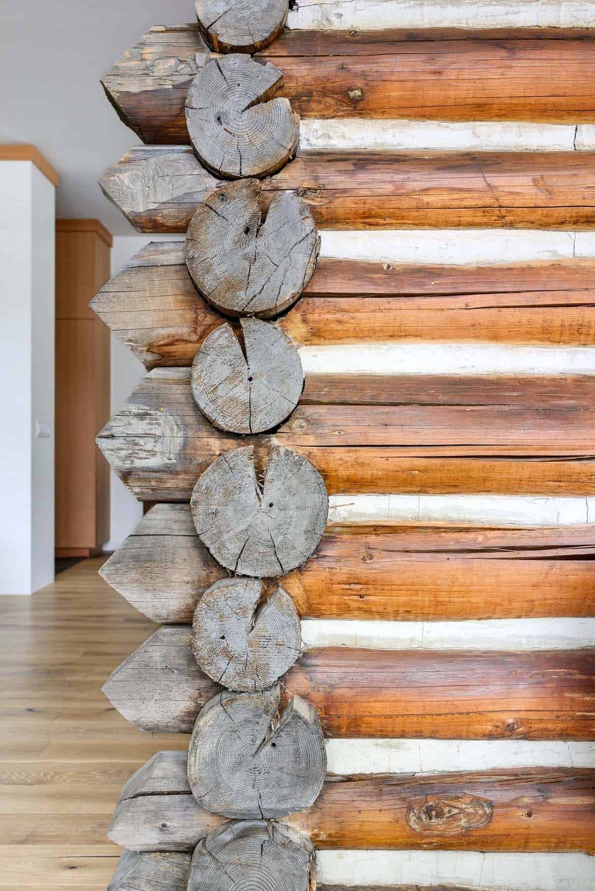Close-up of stacked log ends showing chinking and construction detail