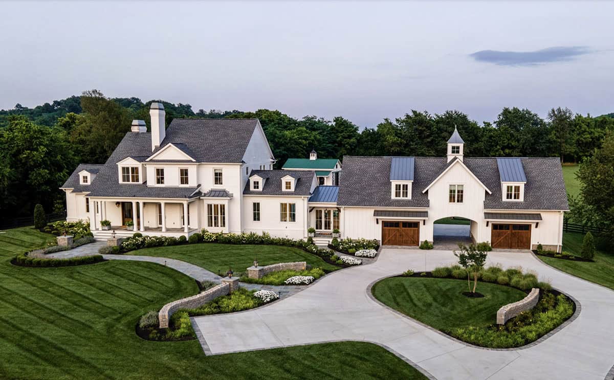 Wide exterior view of the modern farmhouse showing main house and connected barn-style garage