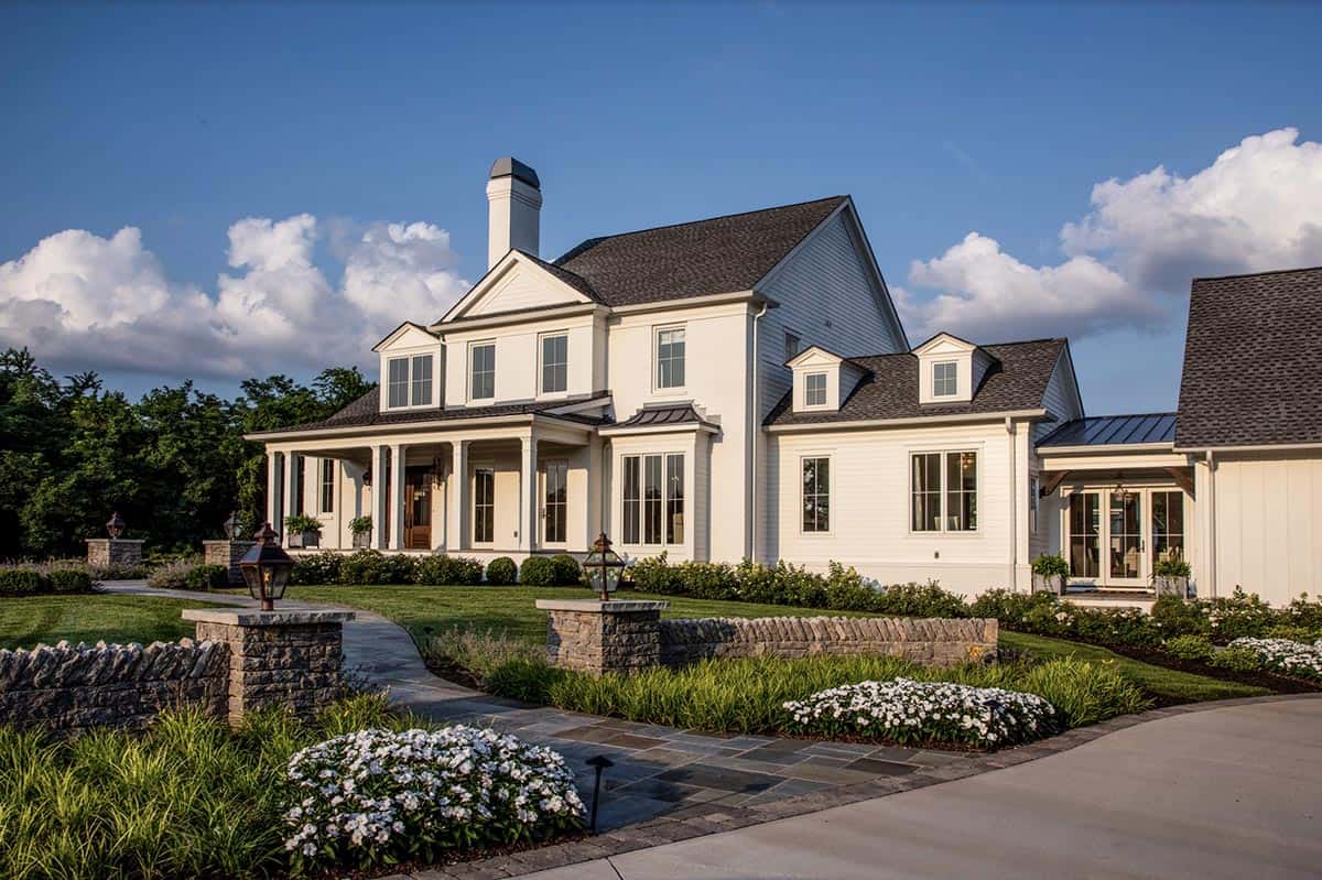 Front view of the farmhouse's two-story section with covered porch and stone walkway