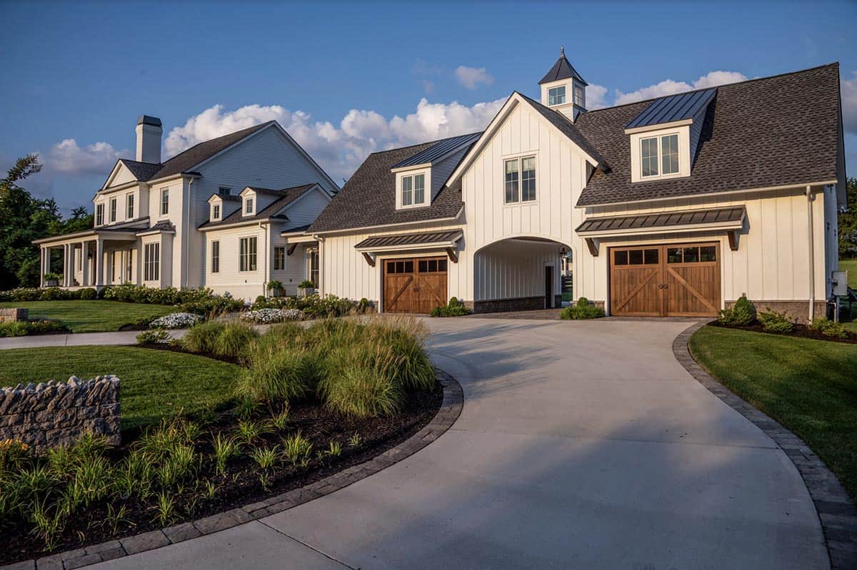 Barn-style garage with wood carriage doors and central breezeway archway