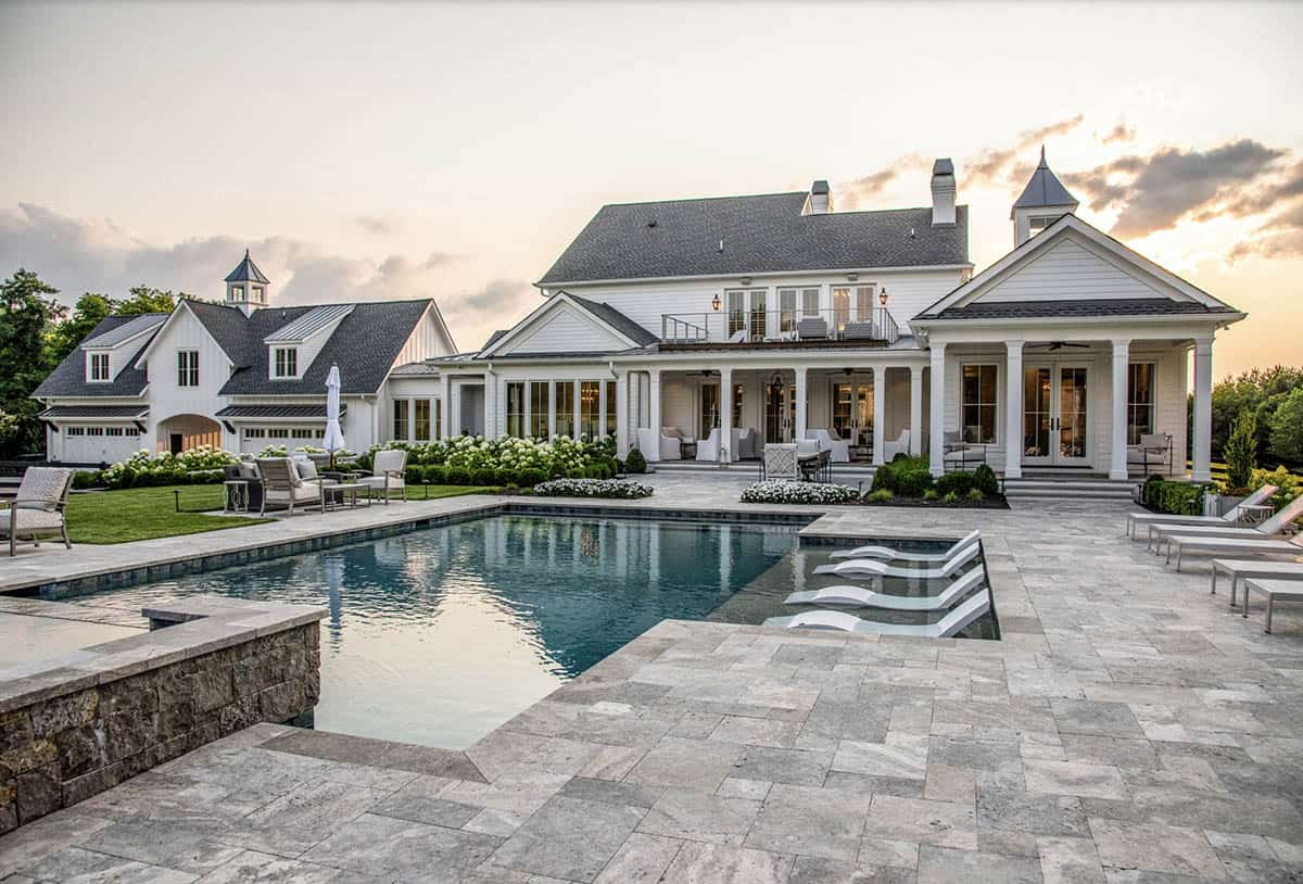 Sunset view of the backyard pool, patio, and connected home structures