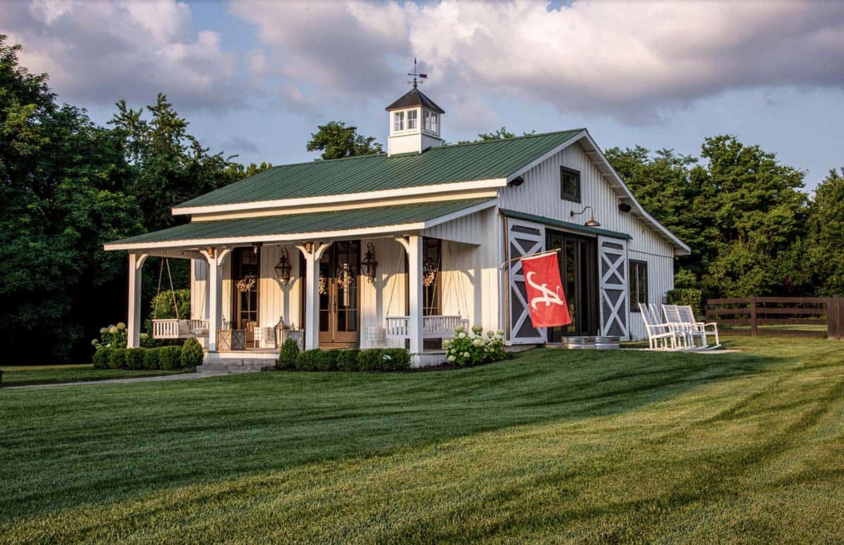 Green-roofed pool house with covered porch swings and Alabama flag at golden hour