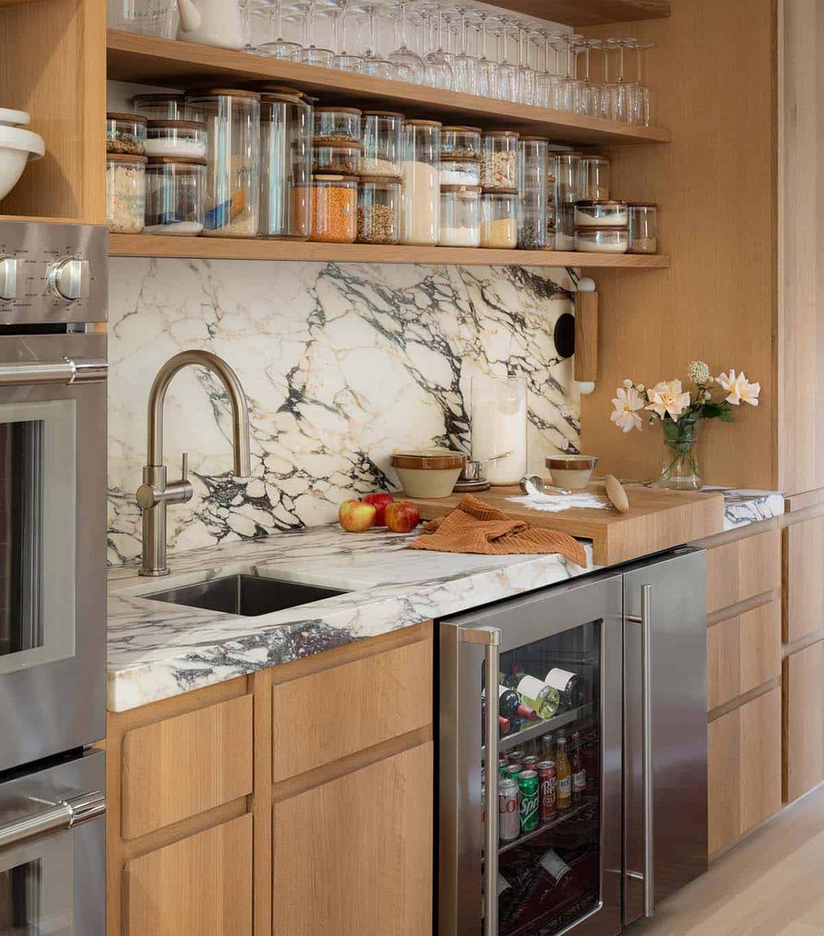 Kitchen prep area with marble backsplash, open shelving, and a built-in wine fridge