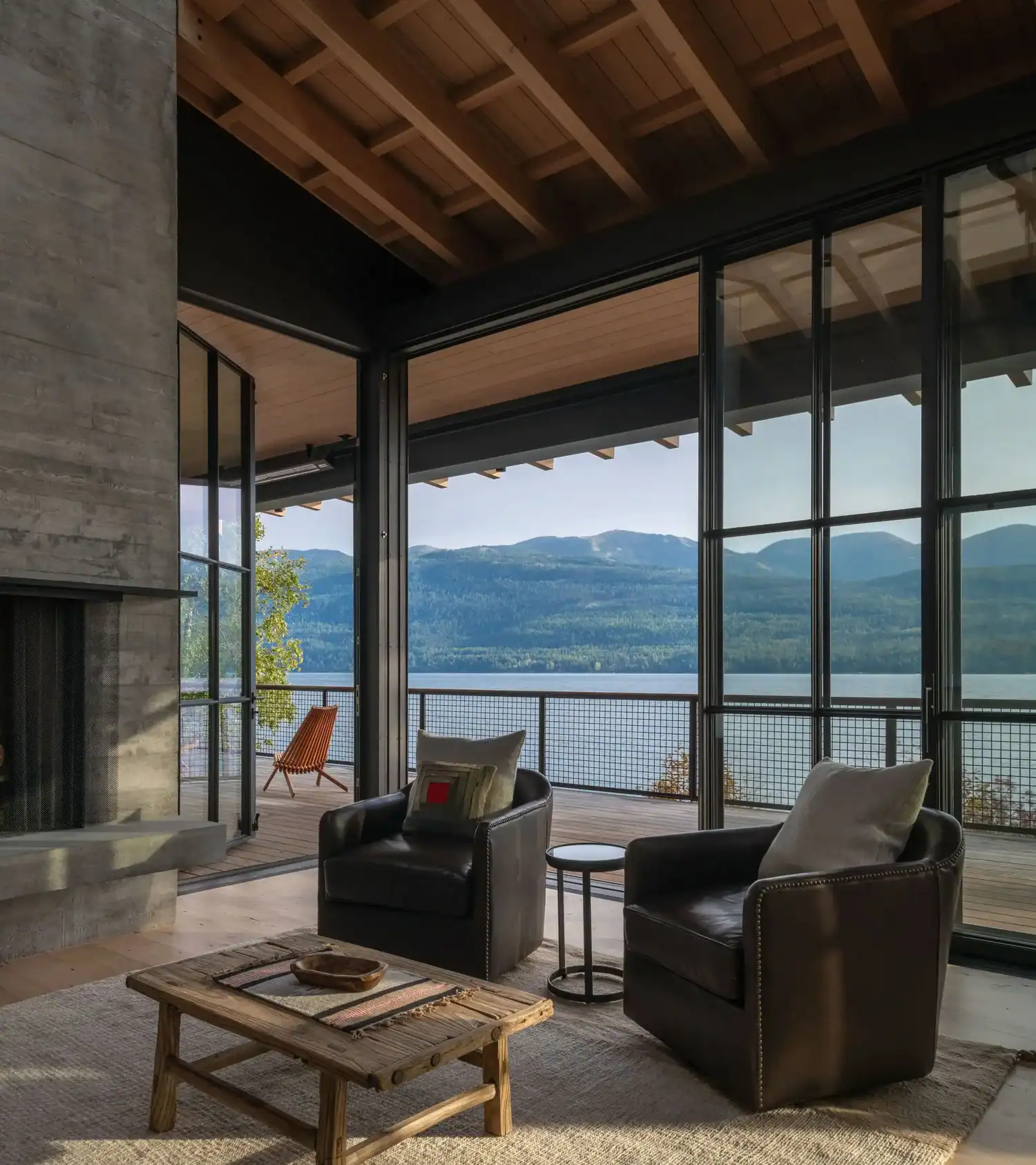 Living room seating area framed by steel windows