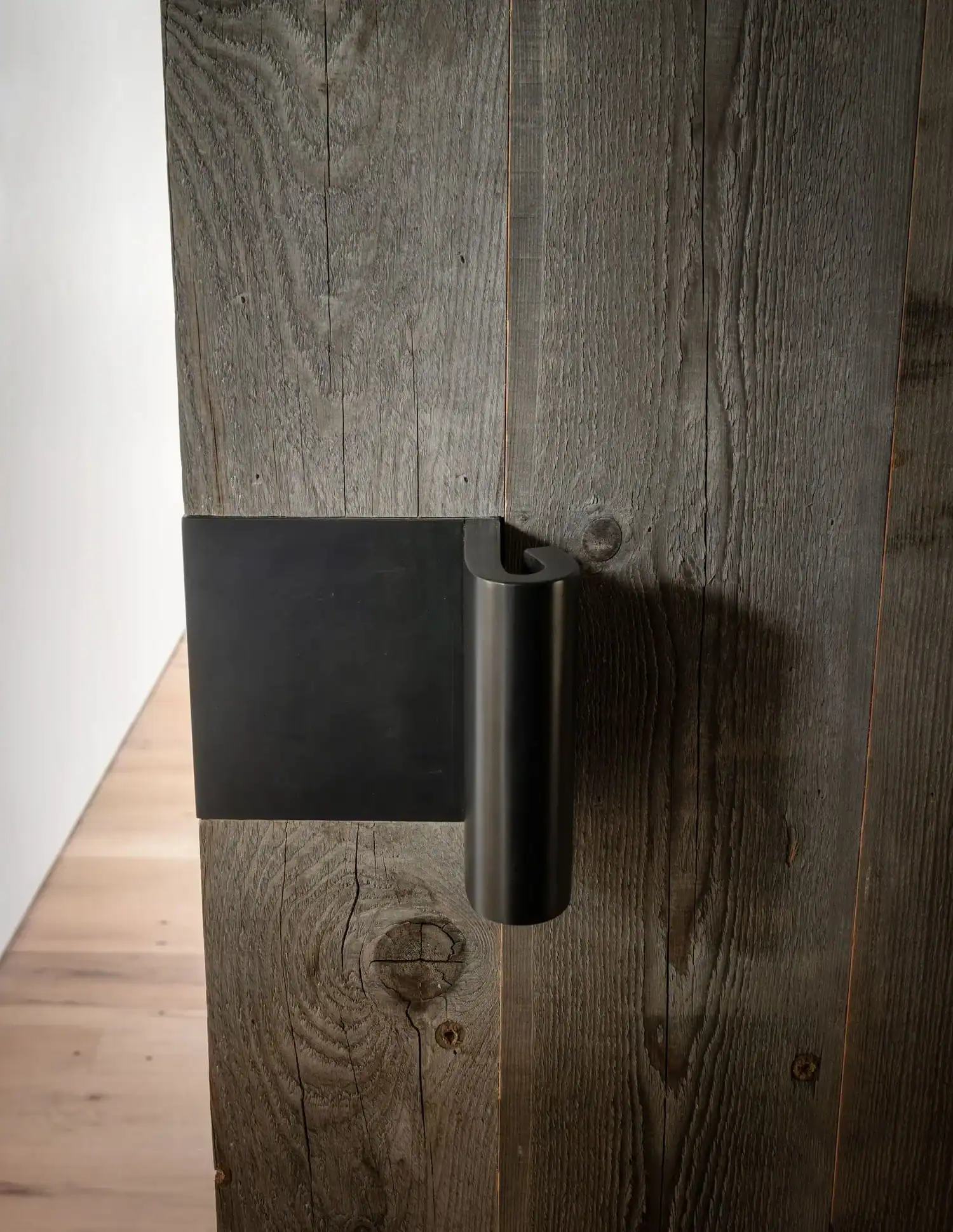 Reclaimed wood wall detail with black hardware