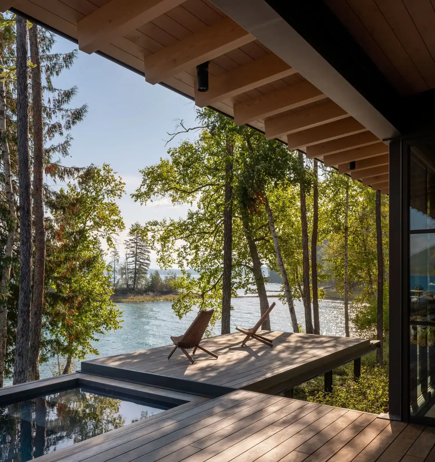Cantilevered deck with lounge chairs above the lake