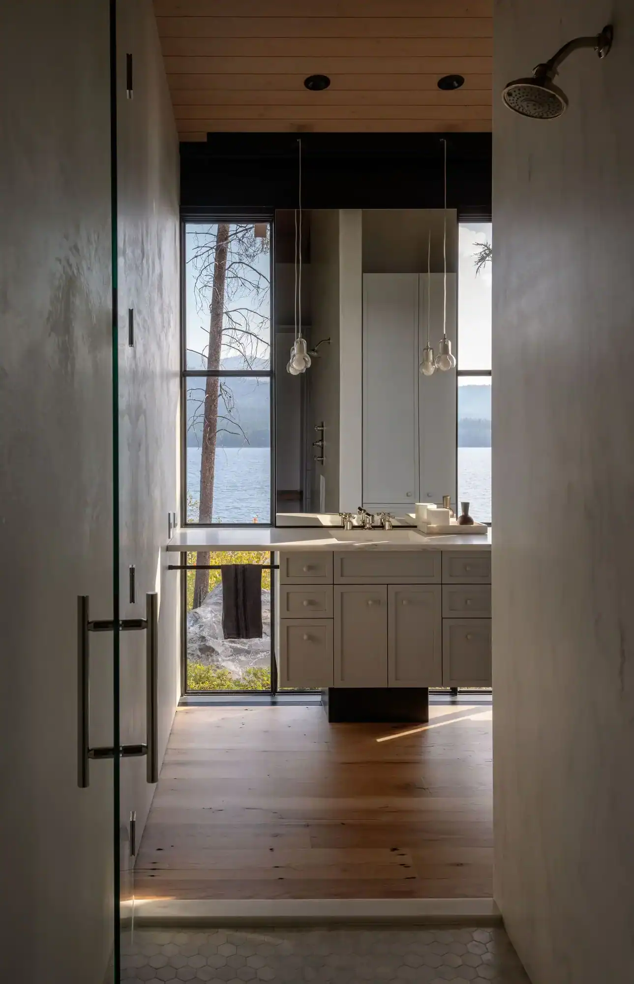 Bathroom vanity with pendant lighting and lake view