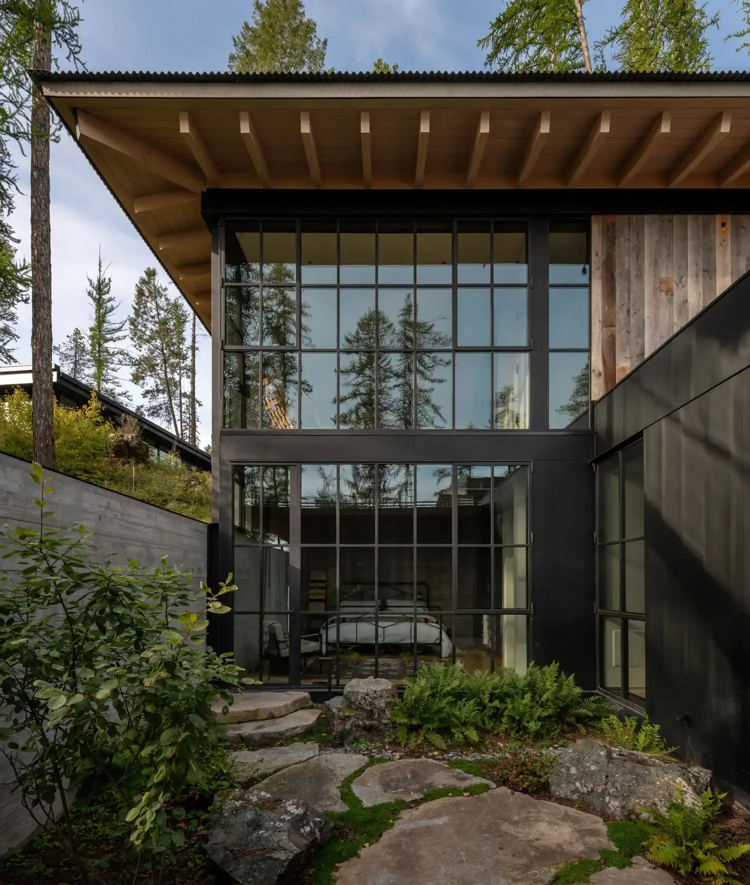 Exterior view into glass-walled bedroom suite