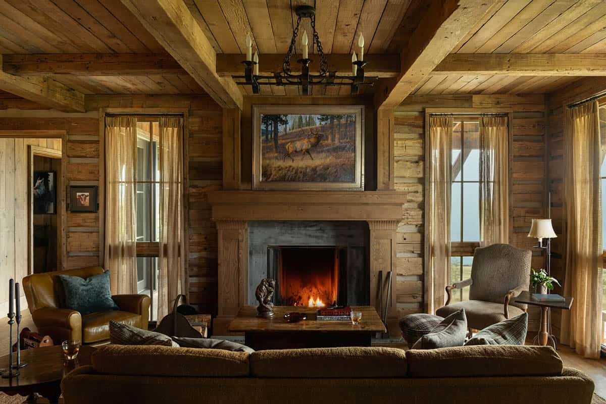 Living room with carved wood fireplace mantel and elk painting above