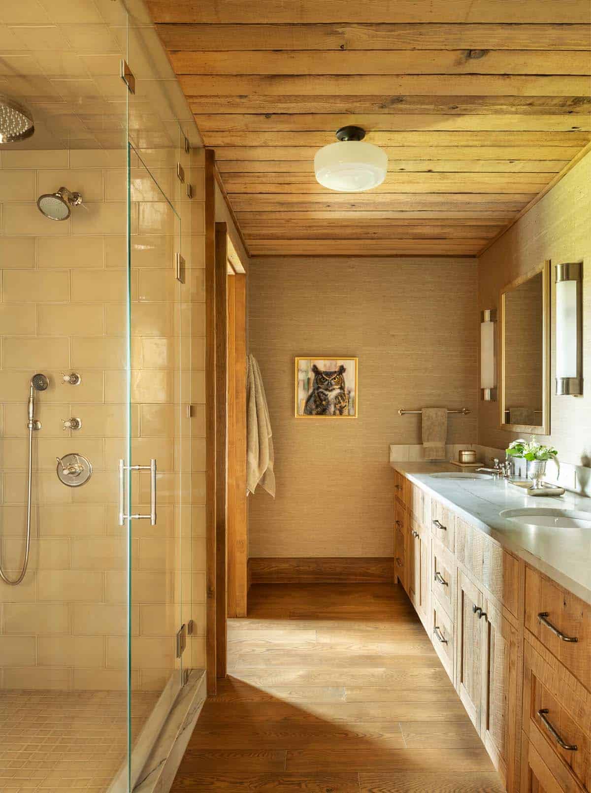 Bathroom hallway with tiled glass shower and an owl painting on grasscloth wallpaper