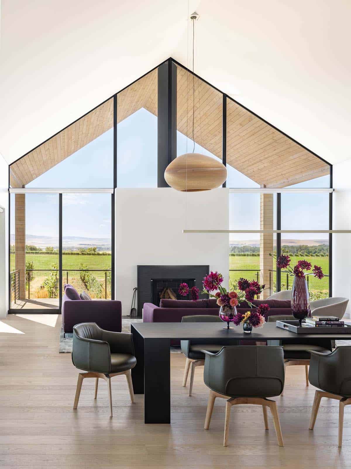 Vaulted living room with wood-lined pitched ceiling and vineyard views