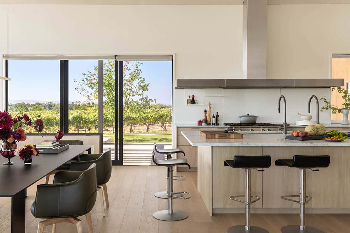 Open kitchen and dining area with sliding glass doors to vineyard