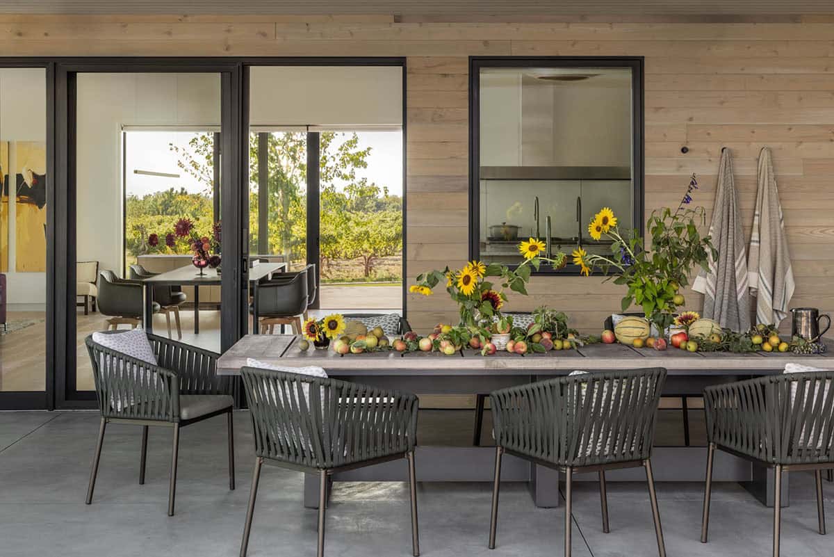 Outdoor dining table styled with sunflowers and seasonal produce
