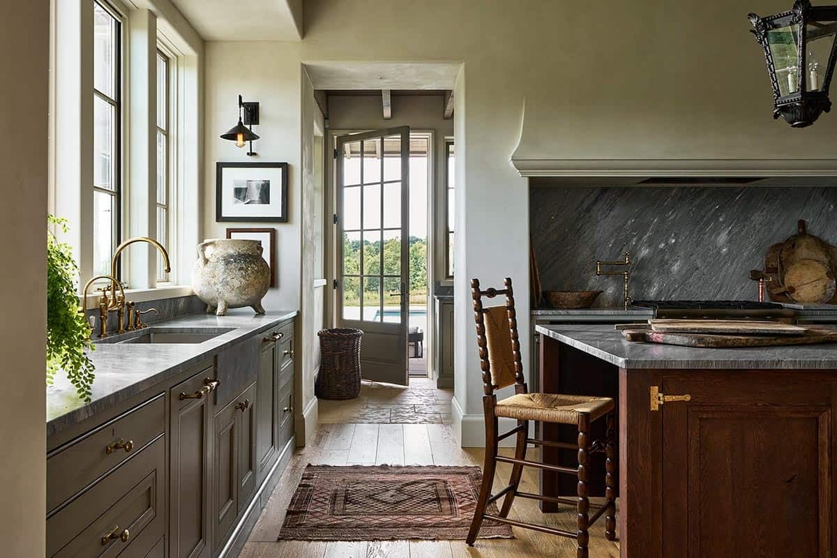 Scullery kitchen with soapstone counters, brass fixtures and antique stone urn
