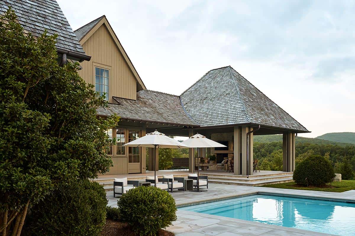 Covered stone patio and pool overlooking layered Tennessee mountain ridgelines