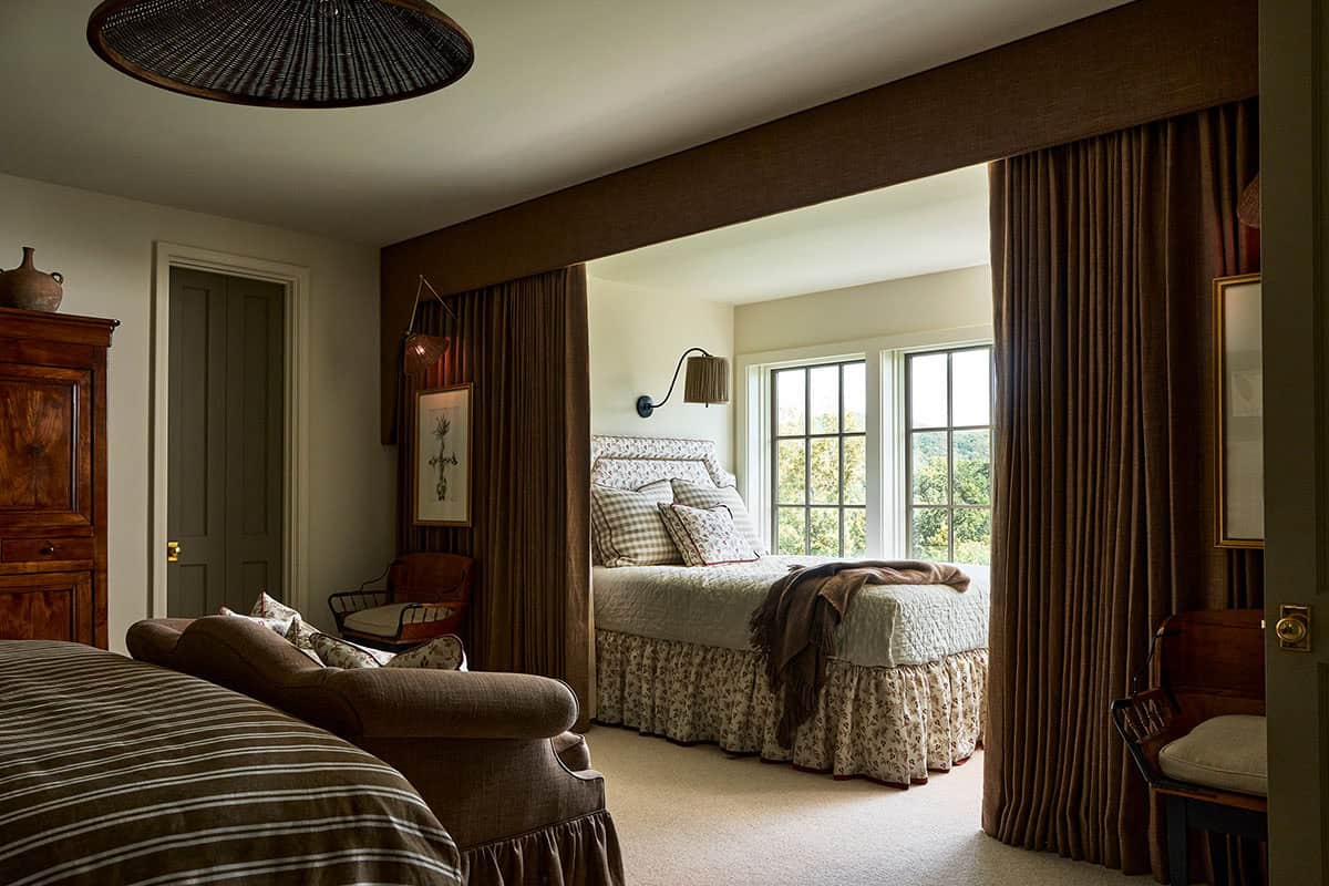 Curtained bed alcove with floral bedding and picture window views