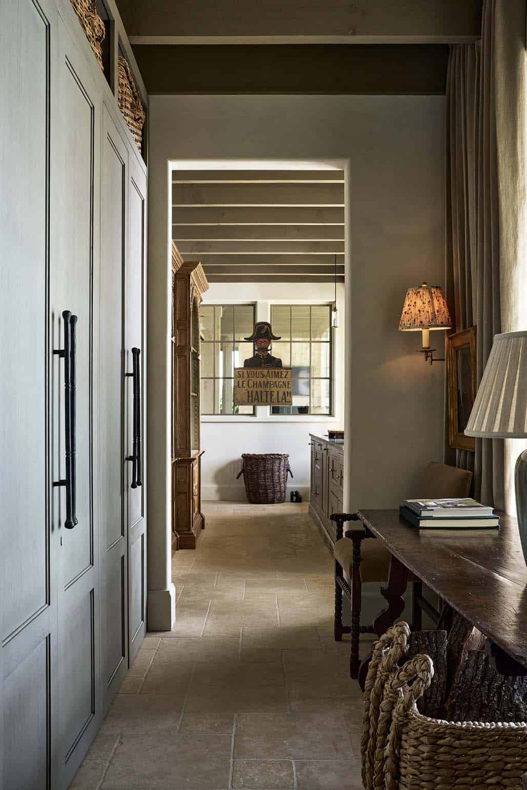 Plaster hallway leading to vintage French champagne sign and wicker basket