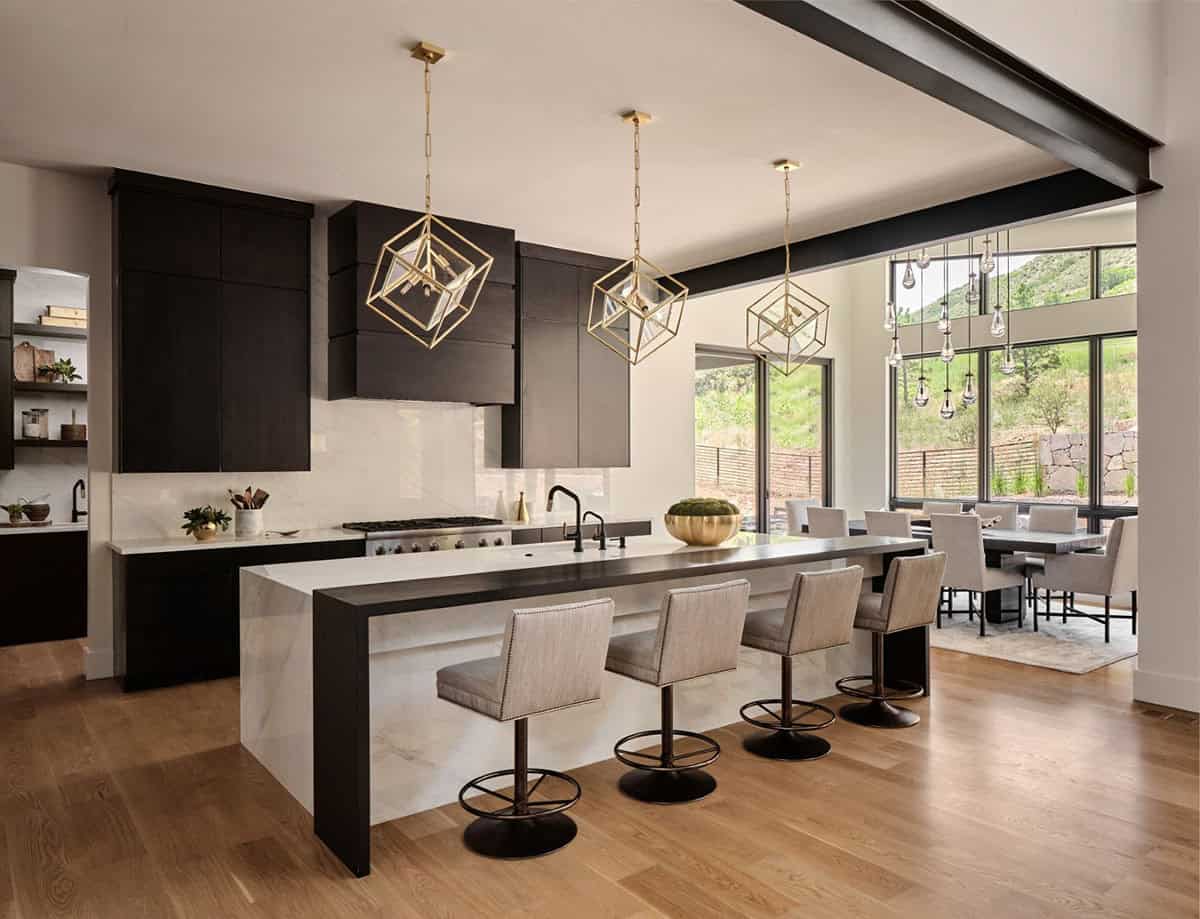 Kitchen island view toward dining area with cube pendant lights and mountain views