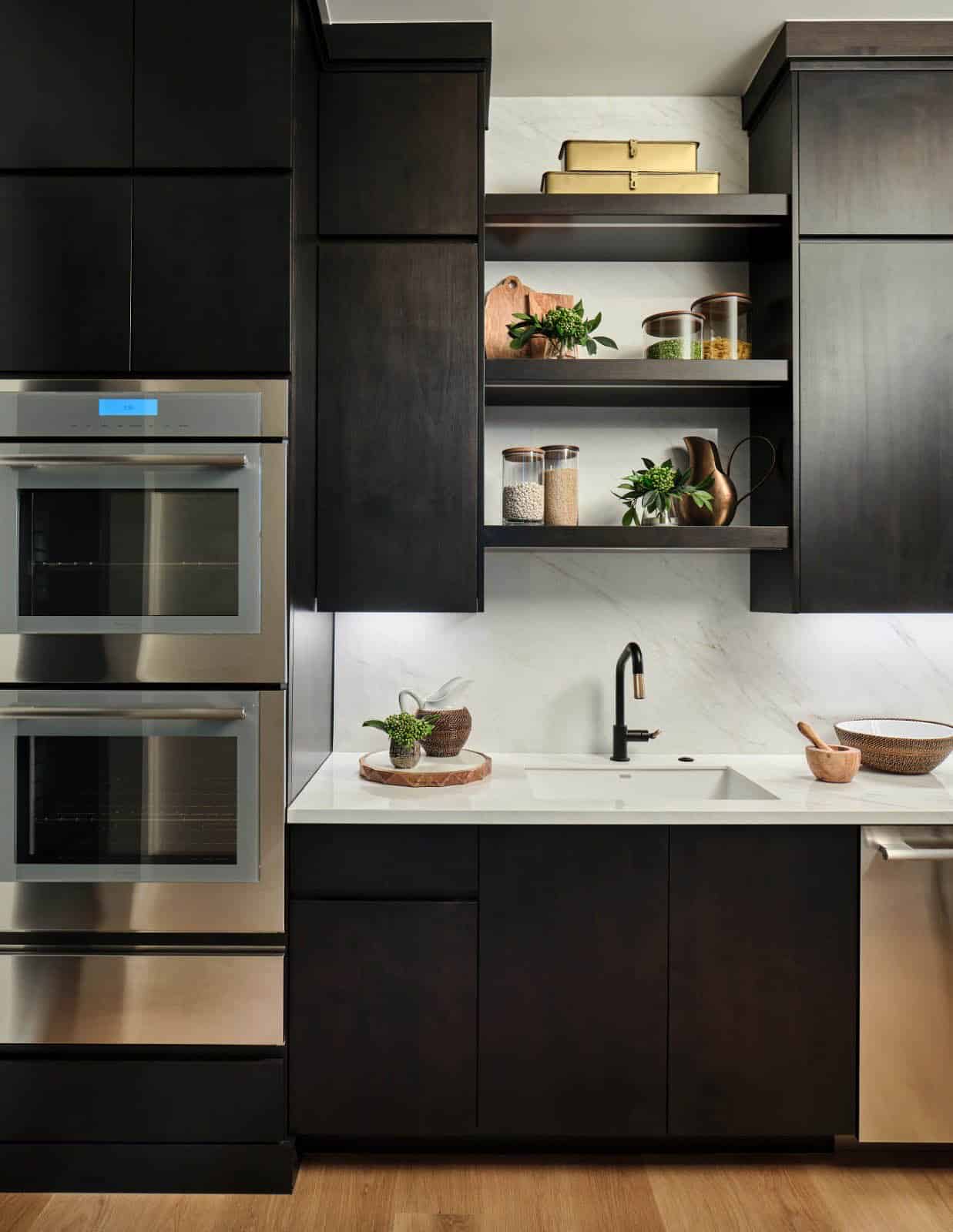 Kitchen prep sink with open shelving, marble backsplash, and double wall ovens