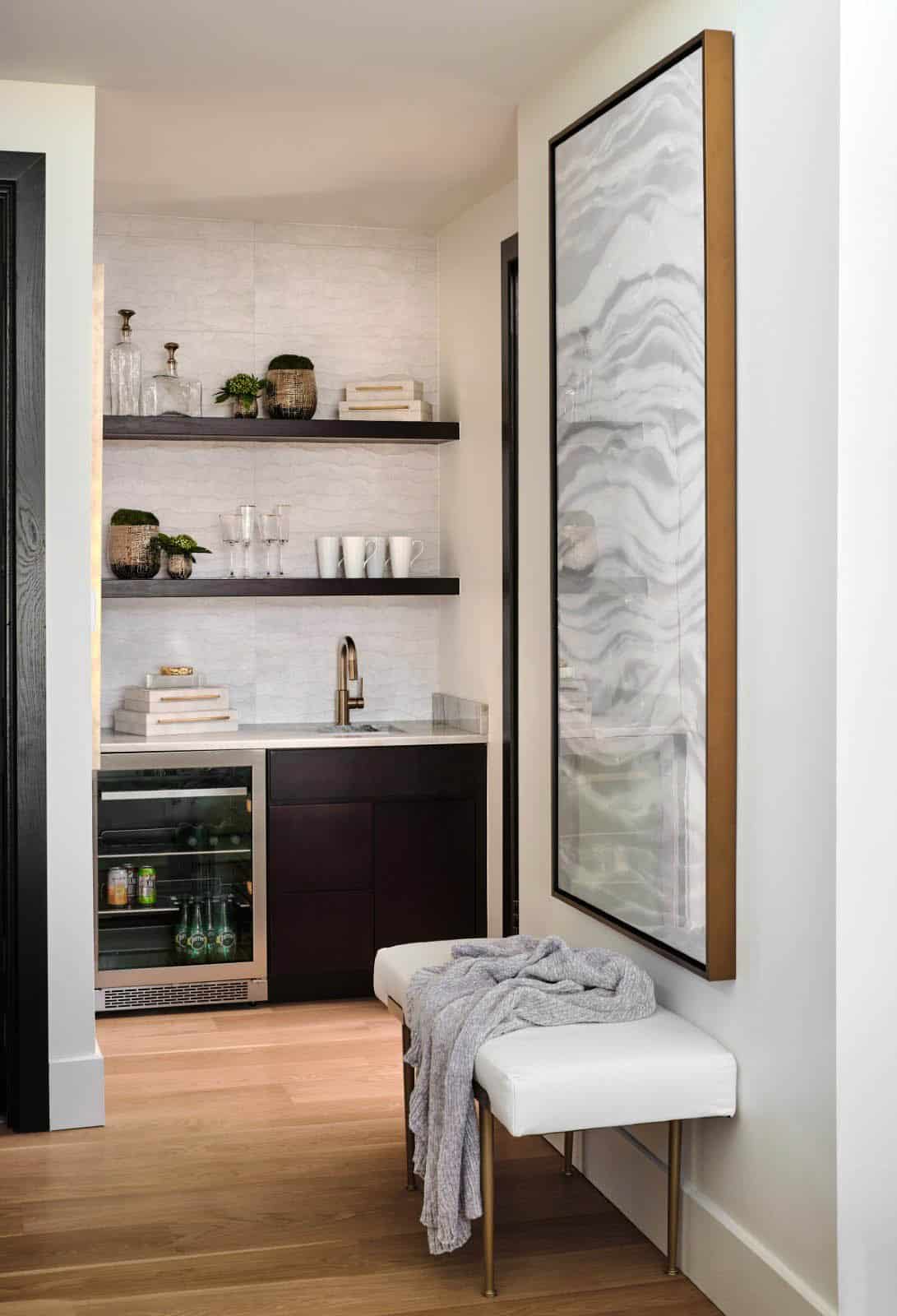 Wet bar nook with open shelving, wine fridge, and tall abstract marble artwork