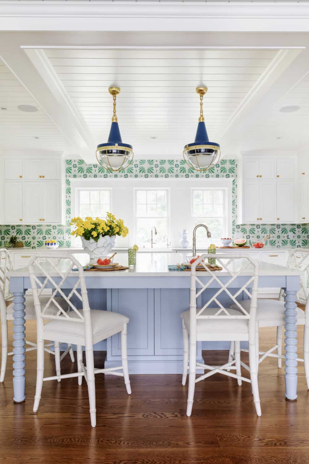 Kitchen island with light blue base and green leaf tile backsplash