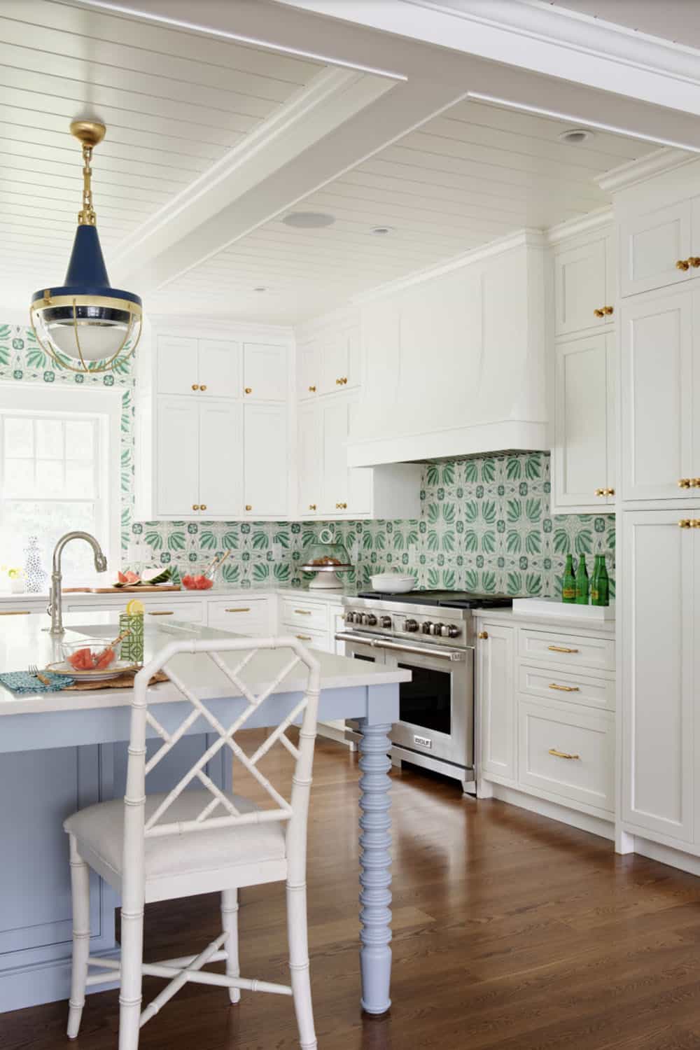 Kitchen corner showing range hood and scalloped bamboo counter stool