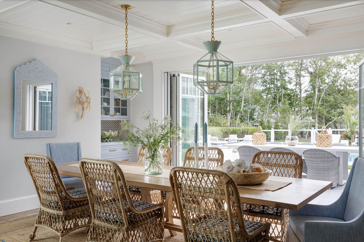Open dining area with folding doors leading to outdoor pool deck